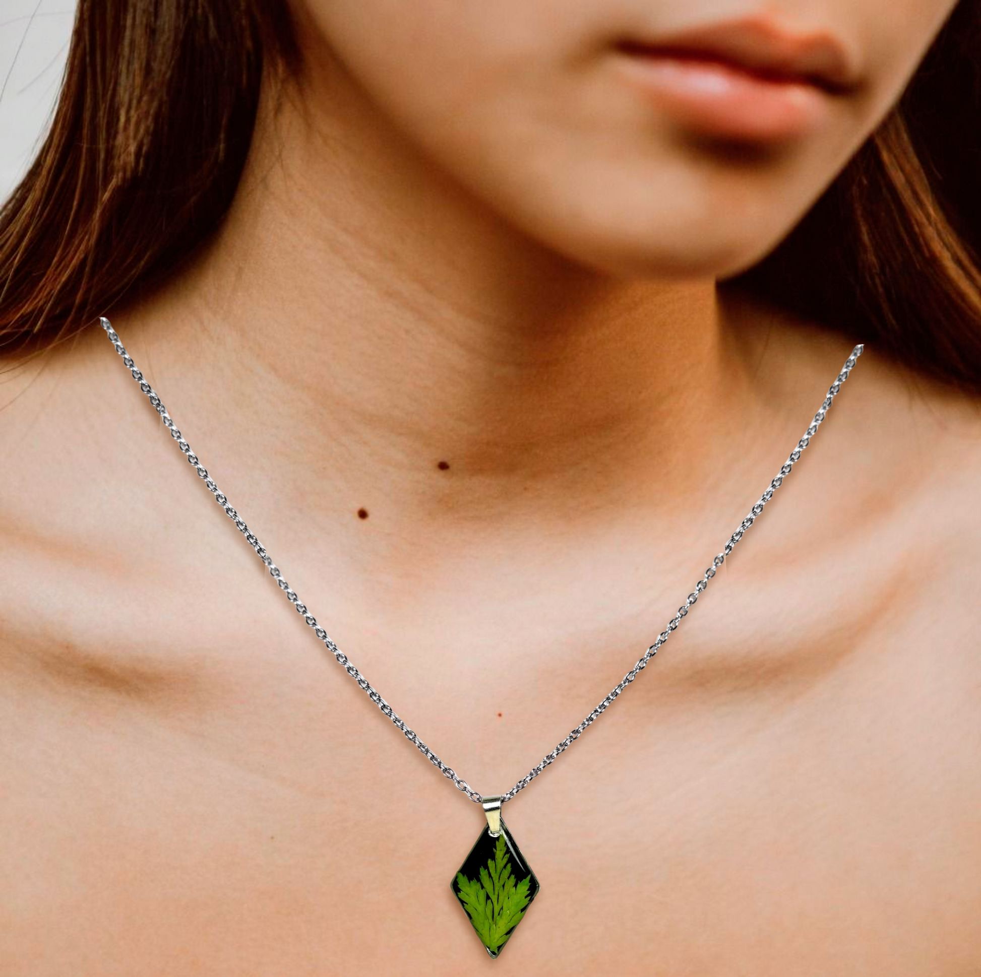 Necklace with a green pendant worn by a person